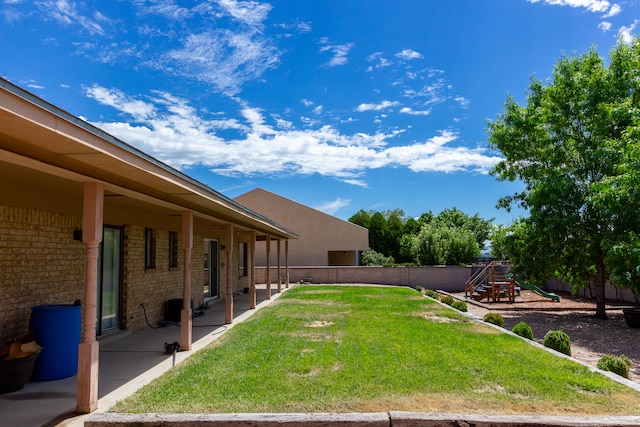 view of yard with a playground and a patio area