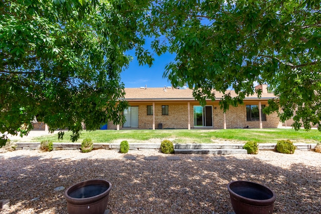 rear view of property with a lawn and a patio area