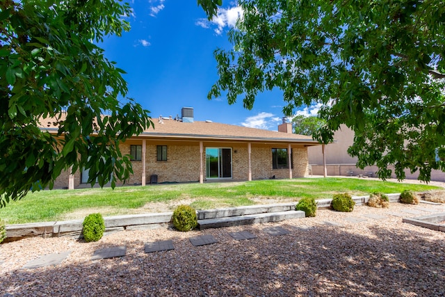 back of property with a lawn and a patio area