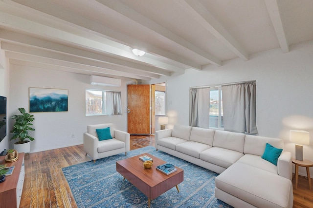 living room with beamed ceiling, an AC wall unit, hardwood / wood-style floors, and a wealth of natural light