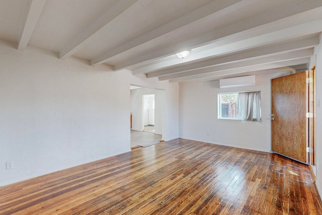 unfurnished room with beam ceiling, hardwood / wood-style flooring, and a wall unit AC