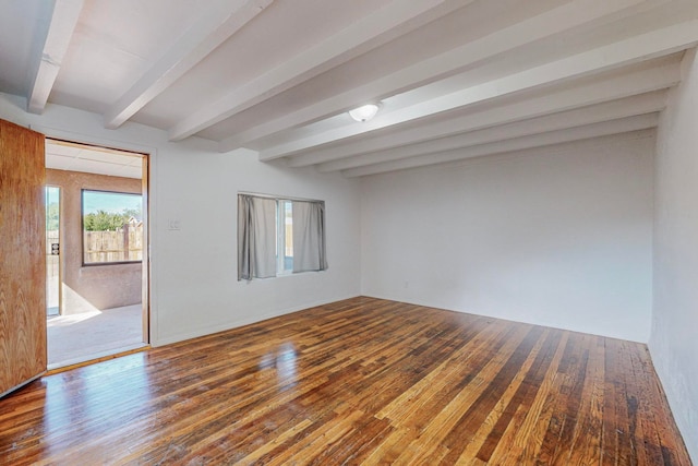 unfurnished room featuring beamed ceiling and wood-type flooring