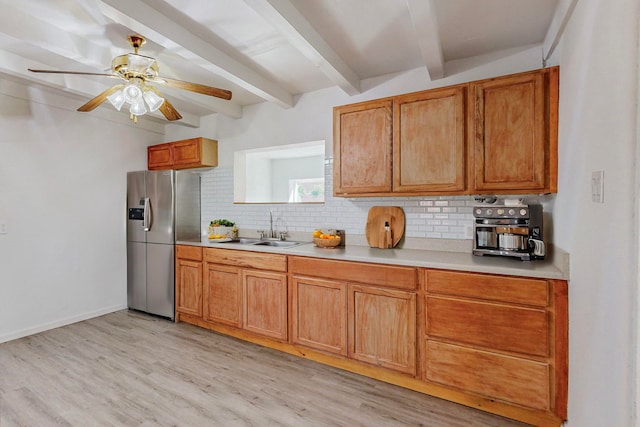 kitchen with sink, decorative backsplash, light wood-type flooring, beam ceiling, and stainless steel fridge with ice dispenser