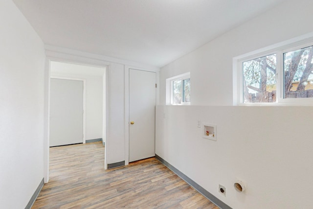 washroom featuring washer hookup, light wood-type flooring, and electric dryer hookup