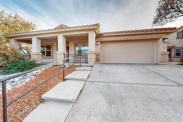 view of front of property featuring covered porch and a garage