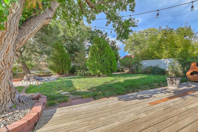 wooden deck featuring a yard