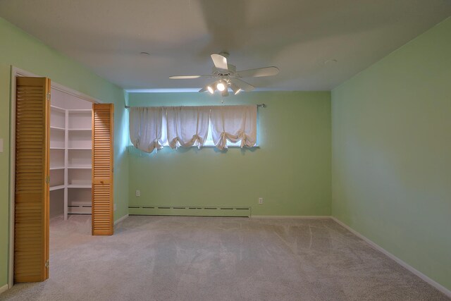 unfurnished bedroom with light carpet, a closet, a baseboard radiator, and ceiling fan