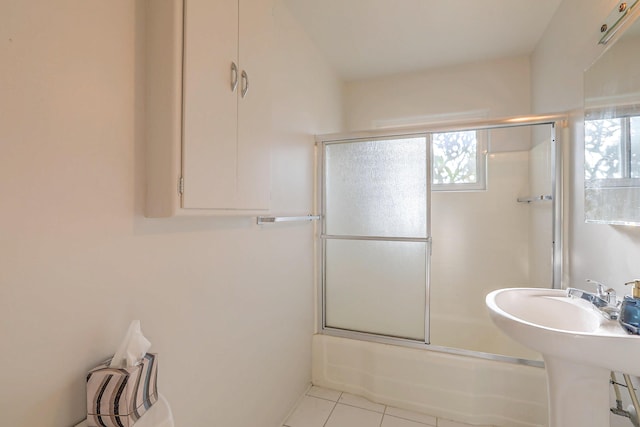 full bath with tile patterned flooring and combined bath / shower with glass door