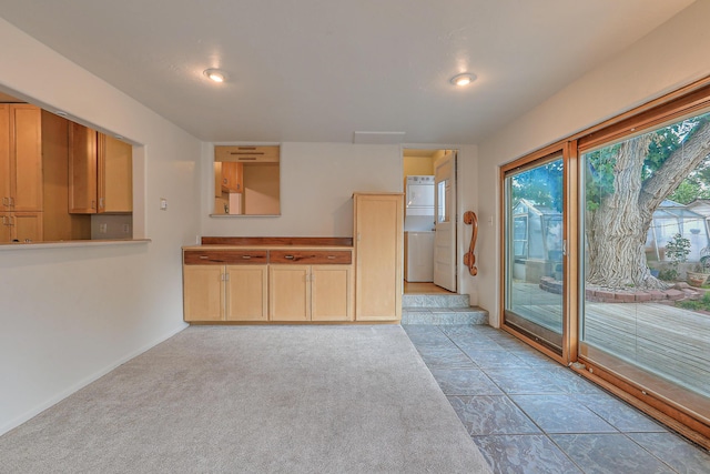 kitchen featuring light colored carpet and light brown cabinets