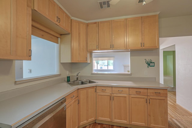 kitchen with light countertops, visible vents, a sink, dishwasher, and a peninsula