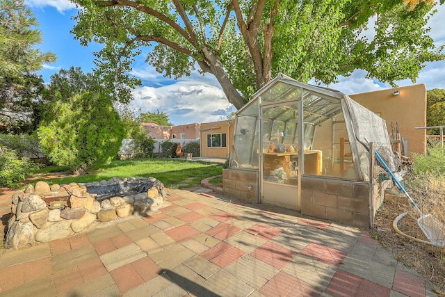 view of patio / terrace featuring fence, an outbuilding, and an exterior structure