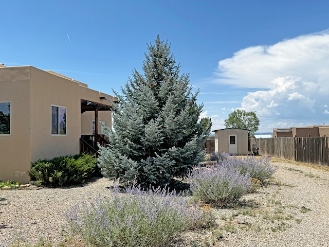 view of side of property with a shed