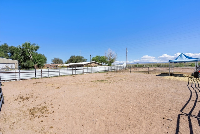 view of yard featuring an enclosed area and a rural view
