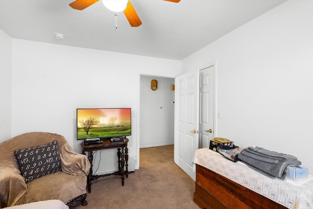 carpeted office featuring ceiling fan