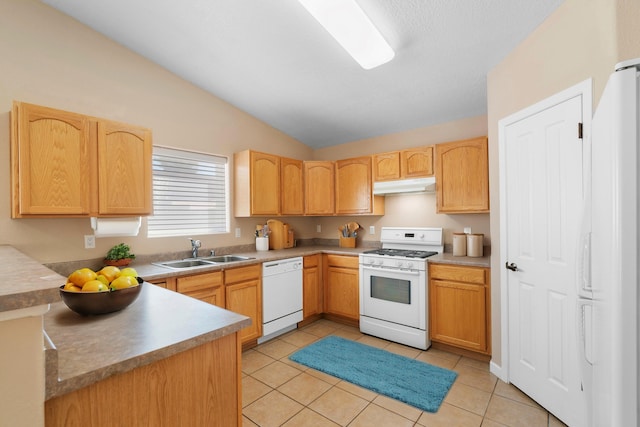 kitchen with white appliances, sink, light tile patterned floors, and vaulted ceiling