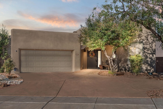 8116 Cayenne Dr NW, Albuquerque, NM 87120 - southwest-style home with concrete driveway, a garage, and stucco siding