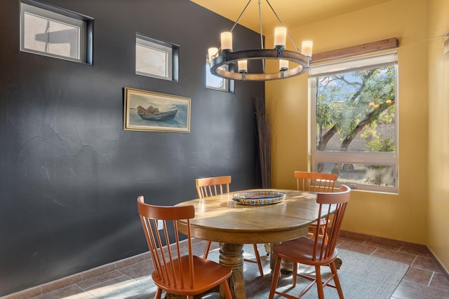 dining area featuring tile patterned flooring and an inviting chandelier