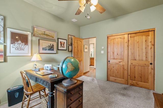 carpeted office with ceiling fan