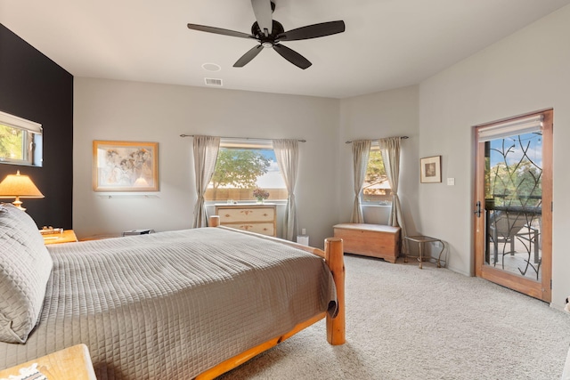 bedroom with access to exterior, ceiling fan, and carpet