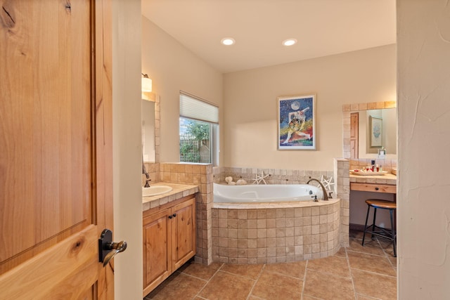 bathroom with vanity, tile patterned floors, and tiled bath