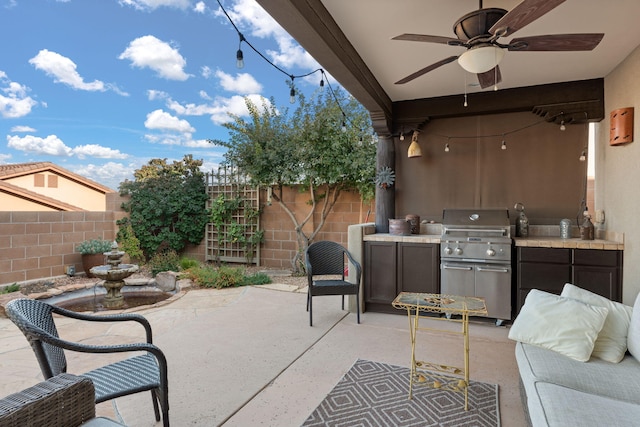 view of patio featuring exterior kitchen, ceiling fan, and area for grilling