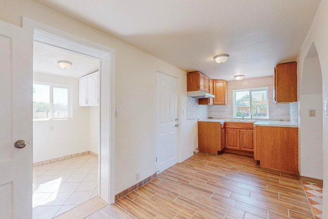 kitchen featuring backsplash, sink, and light hardwood / wood-style floors