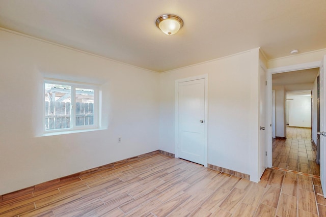 unfurnished bedroom with crown molding, a closet, and light hardwood / wood-style floors