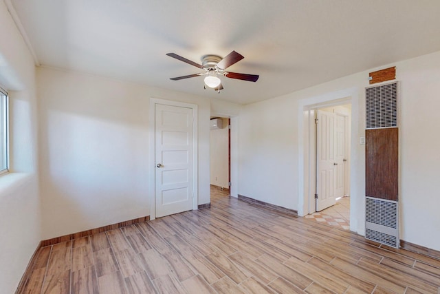 empty room with light hardwood / wood-style flooring and ceiling fan