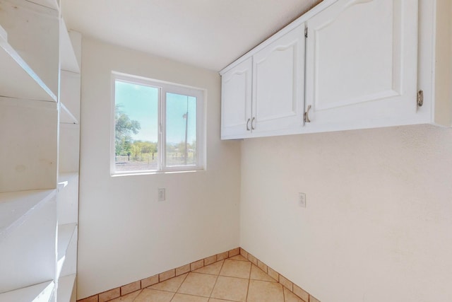 laundry area with light tile patterned floors