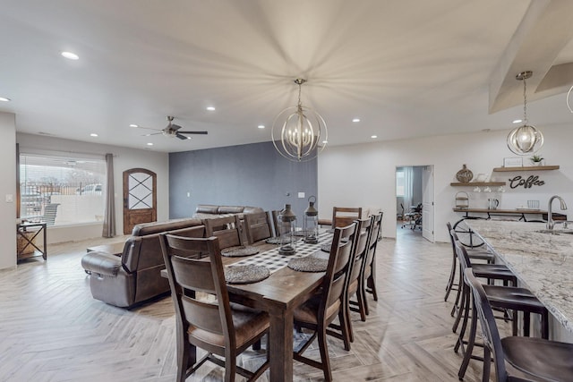 dining space featuring recessed lighting and ceiling fan with notable chandelier