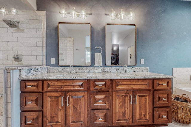 bathroom featuring a shower and vanity