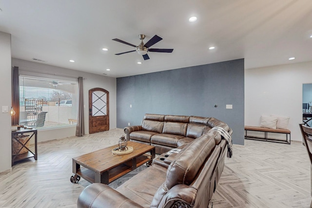 living room featuring light parquet floors and ceiling fan