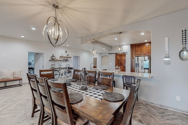 dining area featuring an inviting chandelier, light parquet floors, and sink