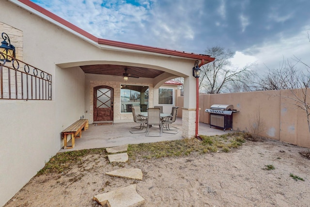 view of patio with area for grilling and ceiling fan