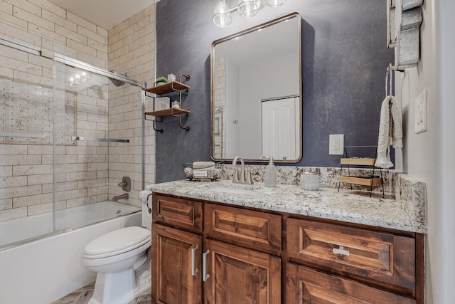 full bath with vanity, toilet, and combined bath / shower with glass door