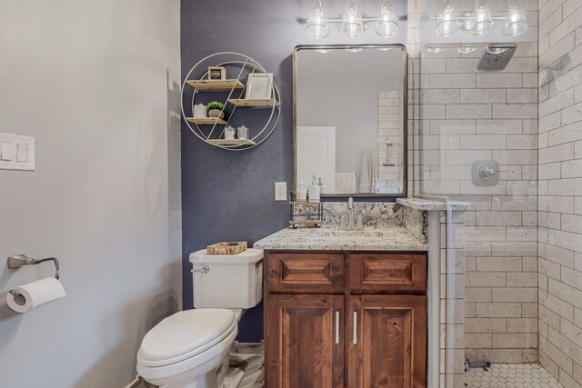full bathroom with tiled shower, toilet, and vanity