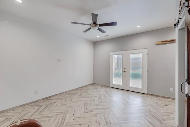 unfurnished room with french doors, ceiling fan, and light parquet flooring