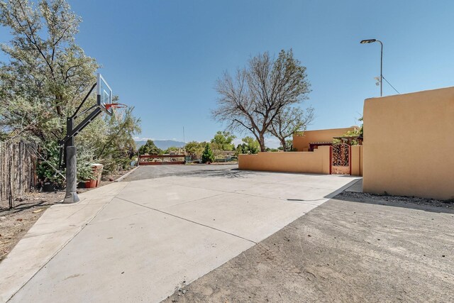 view of patio featuring basketball hoop