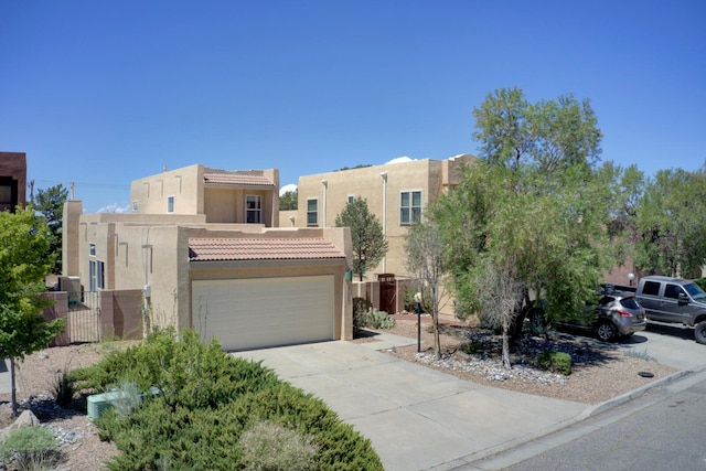 pueblo-style house featuring a garage