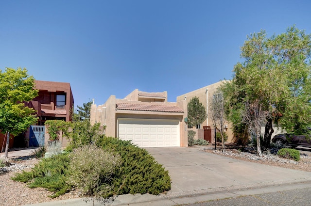 pueblo-style house with a garage