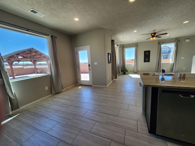 kitchen with baseboards, visible vents, stainless steel dishwasher, and recessed lighting