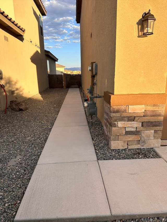 view of home's exterior with fence and stucco siding