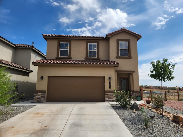 mediterranean / spanish-style home with a garage