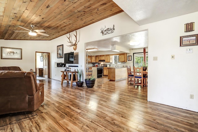 living room featuring ceiling fan, vaulted ceiling, wood ceiling, and light hardwood / wood-style flooring