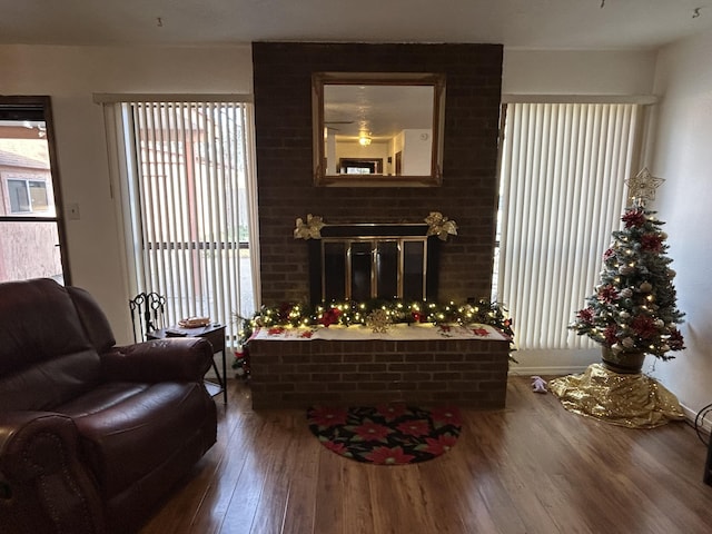 sitting room featuring a fireplace and hardwood / wood-style flooring