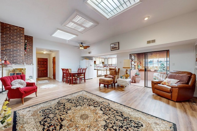 living room featuring ceiling fan and light hardwood / wood-style flooring