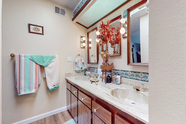 bathroom with hardwood / wood-style flooring and vanity