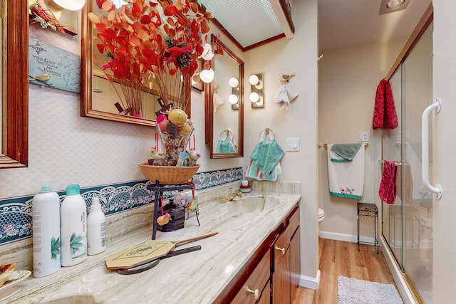 bathroom featuring vanity, hardwood / wood-style flooring, toilet, and walk in shower