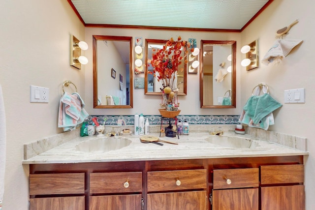 bathroom featuring crown molding and vanity