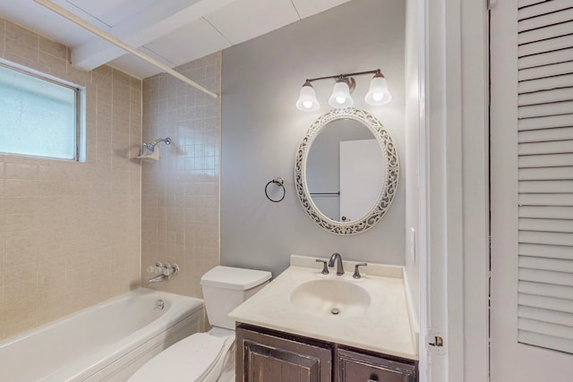 full bathroom featuring tiled shower / bath combo, vanity, and toilet